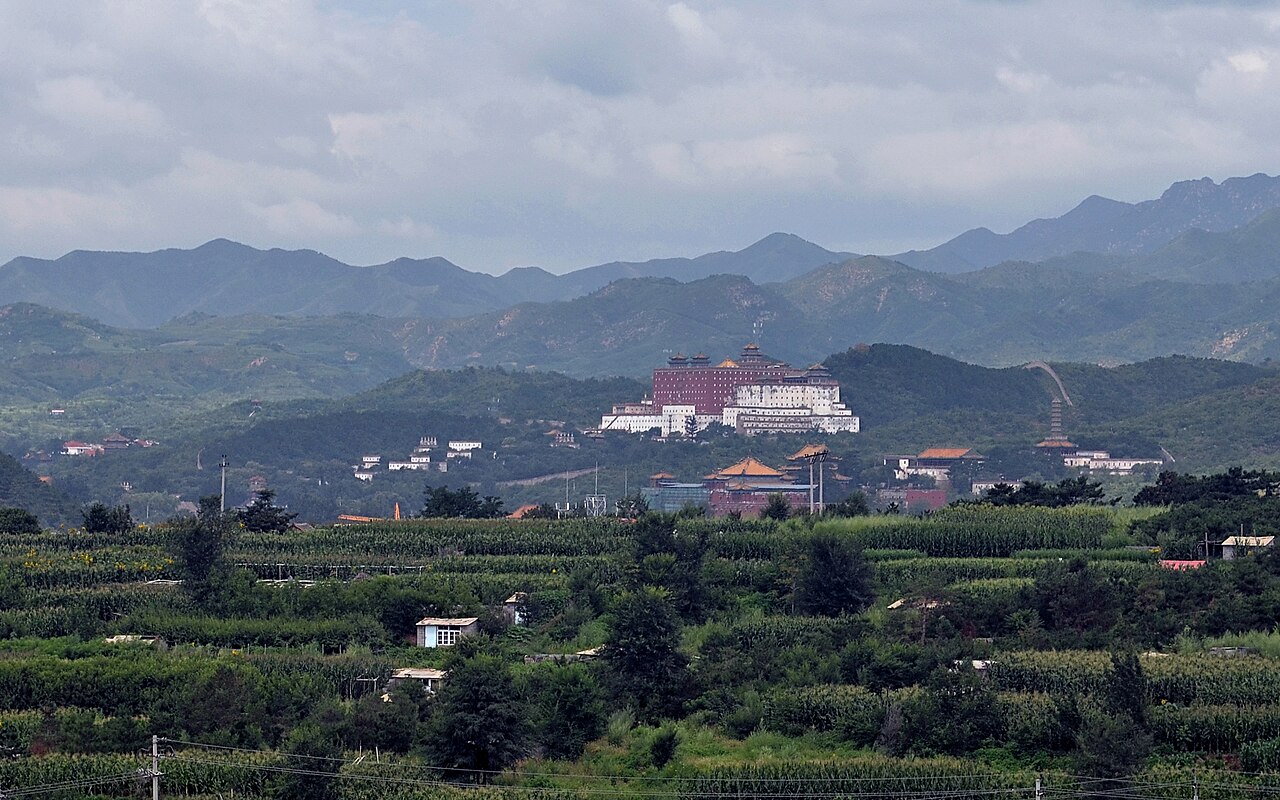 Putuo Zongcheng Temple on a hillside outside Chengde, seen across fields